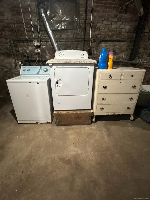 laundry area with washing machine and clothes dryer and laundry area