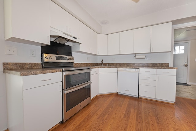 170 Barker Hill Dr, Guilford, CT 06437 - kitchen with white dishwasher, range with two ovens, under cabinet range hood, light wood-type flooring, and white cabinetry