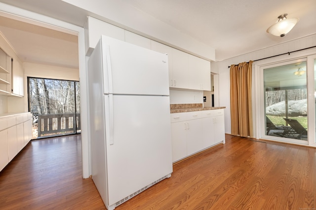 170 Barker Hill Dr, Guilford, CT 06437 - kitchen featuring freestanding refrigerator, light wood-style floors, white cabinetry, light countertops, and open shelves