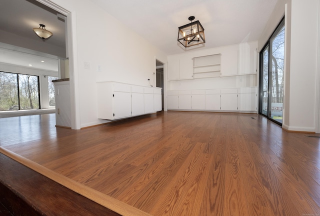 170 Barker Hill Dr, Guilford, CT 06437 - unfurnished living room featuring a chandelier and dark wood-type flooring