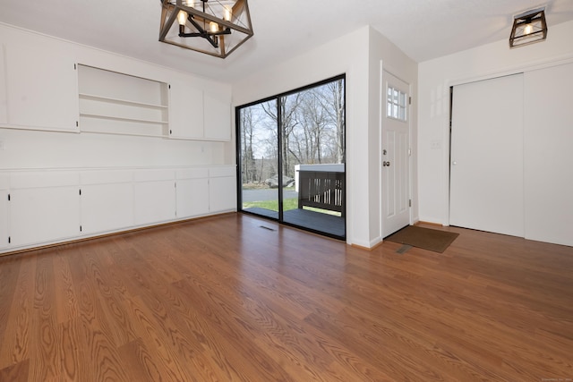 170 Barker Hill Dr, Guilford, CT 06437 - unfurnished dining area featuring a chandelier and wood finished floors