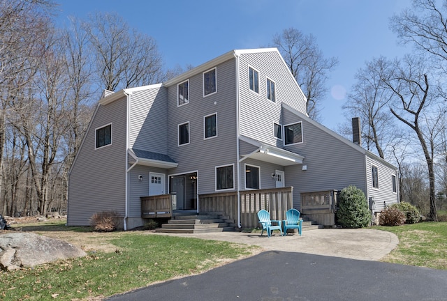 170 Barker Hill Dr, Guilford, CT 06437 - view of front facade featuring a chimney, a front lawn, and a wooden deck