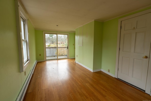 24 Echo Point Rd, Guilford, CT 06437 - spare room with a baseboard radiator, ornamental molding, and wood finished floors