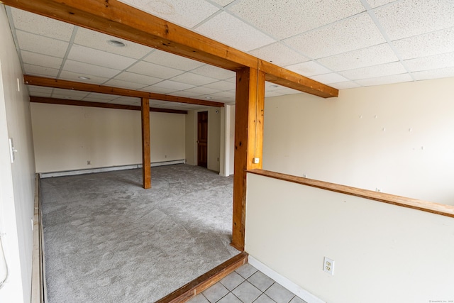 24 Echo Point Rd, Guilford, CT 06437 - finished basement featuring a paneled ceiling, a baseboard radiator, carpet, and tile patterned flooring