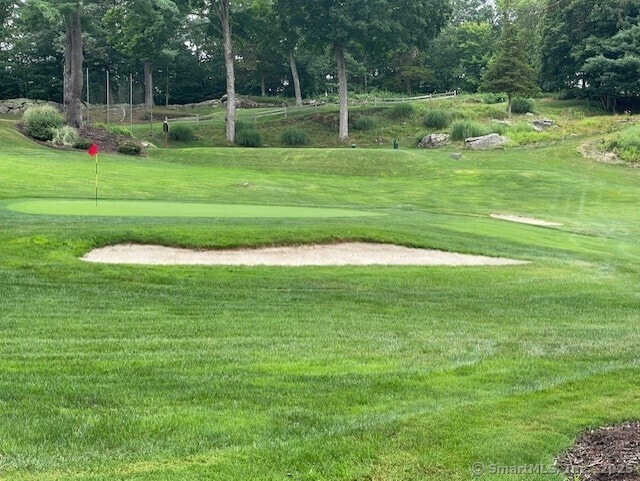 24 Echo Point Rd, Guilford, CT 06437 - view of community featuring view of golf course, a putting area, a yard, and view of wooded area