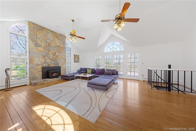 living area featuring ceiling fan, a baseboard heating unit, high vaulted ceiling, and hardwood / wood-style floors