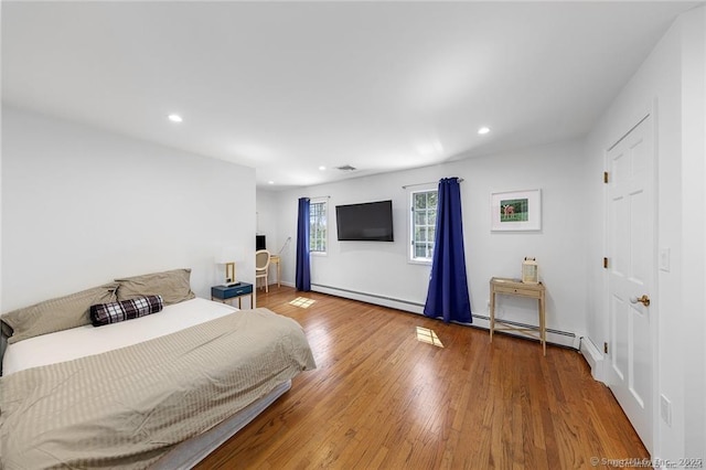 bedroom featuring recessed lighting, a baseboard radiator, baseboard heating, and visible vents