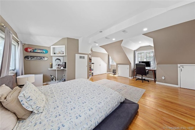 bedroom with recessed lighting, visible vents, wood finished floors, and lofted ceiling