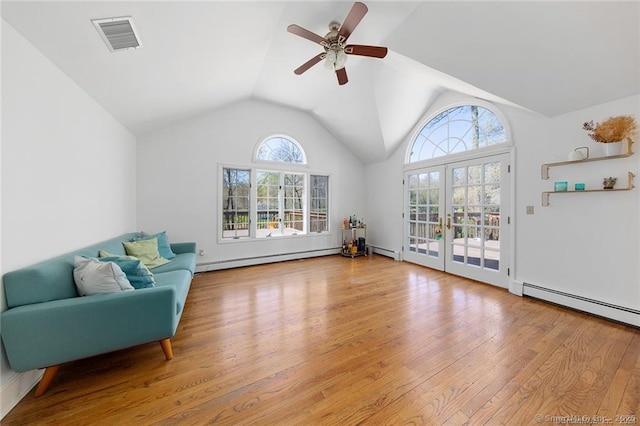 unfurnished room with a wealth of natural light, a baseboard radiator, a ceiling fan, and visible vents