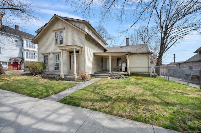 view of front of property featuring covered porch, fence, a front lawn, a gate, and a chimney
