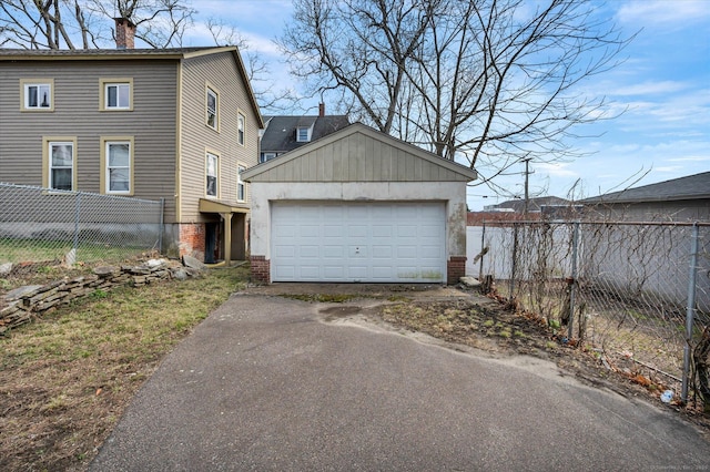 view of side of property with fence, a chimney, an outbuilding, and a detached garage