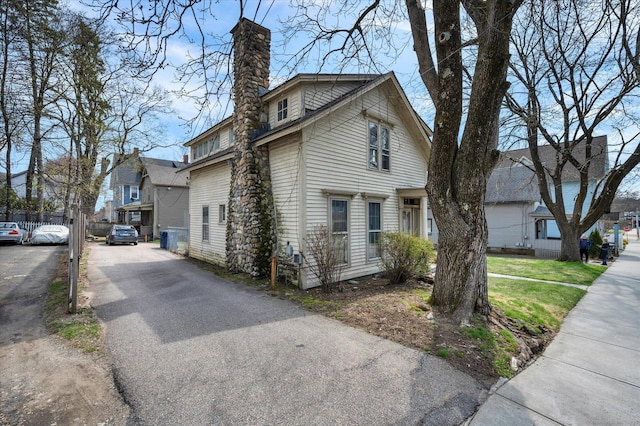 view of property exterior featuring a chimney
