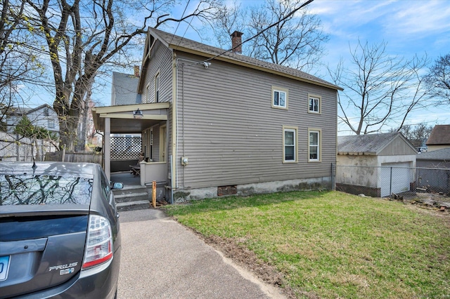 view of property exterior featuring a yard, fence, and a chimney