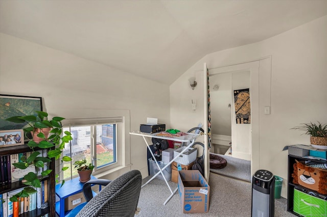 carpeted office space featuring vaulted ceiling