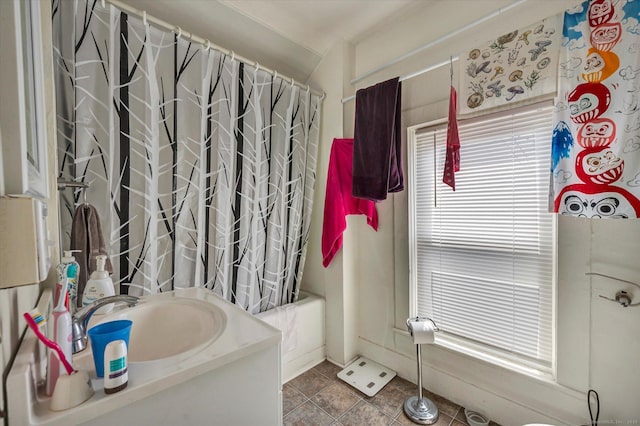 full bathroom featuring a healthy amount of sunlight, vanity, and shower / bathtub combination with curtain