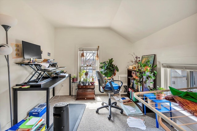 office area with a wealth of natural light, carpet, and vaulted ceiling