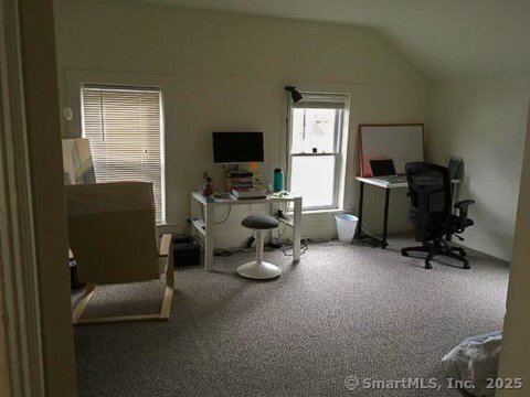 office area with lofted ceiling and carpet floors