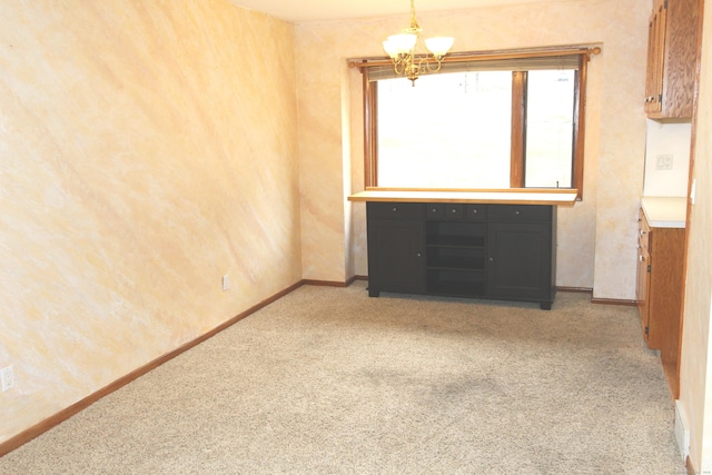 112 Paugassett Ln Unit 112, Shelton, CT 06484 - spare room with light colored carpet, a chandelier, and baseboards