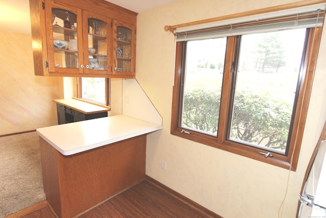112 Paugassett Ln Unit 112, Shelton, CT 06484 - kitchen with glass insert cabinets, brown cabinets, healthy amount of natural light, and light countertops