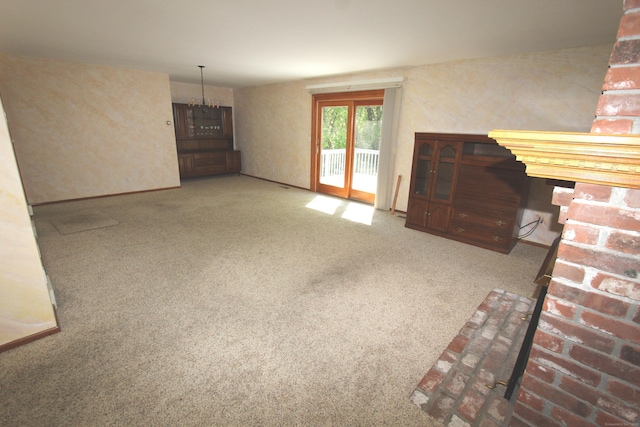 112 Paugassett Ln Unit 112, Shelton, CT 06484 - unfurnished living room with carpet flooring and a chandelier