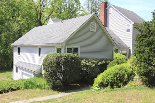 112 Paugassett Ln Unit 112, Shelton, CT 06484 - view of property exterior featuring a chimney and a shingled roof