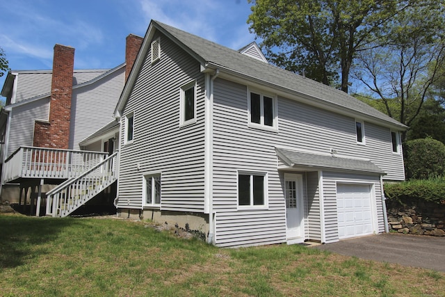 112 Paugassett Ln Unit 112, Shelton, CT 06484 - view of home's exterior with a garage, a wooden deck, a yard, stairway, and asphalt driveway
