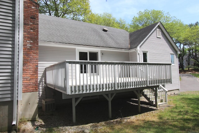112 Paugassett Ln Unit 112, Shelton, CT 06484 - rear view of house featuring a shingled roof, a wooden deck, a chimney, and stairs