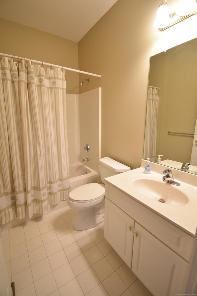 bathroom featuring toilet, shower / bath combo with shower curtain, tile patterned flooring, and vanity