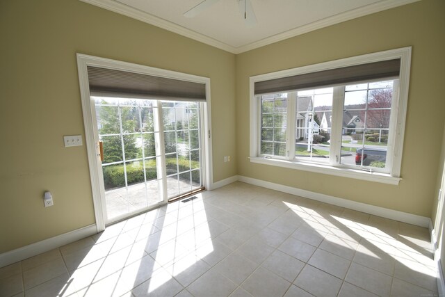 unfurnished room featuring visible vents, baseboards, a ceiling fan, crown molding, and tile patterned floors
