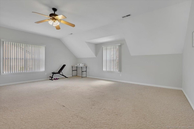 additional living space with visible vents, ceiling fan, vaulted ceiling, and baseboards
