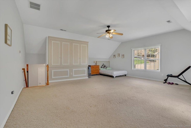 bedroom featuring light carpet, baseboards, lofted ceiling, and visible vents