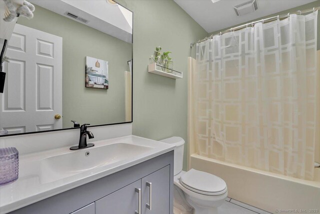 full bathroom featuring toilet, vanity, shower / bath combination with curtain, and visible vents