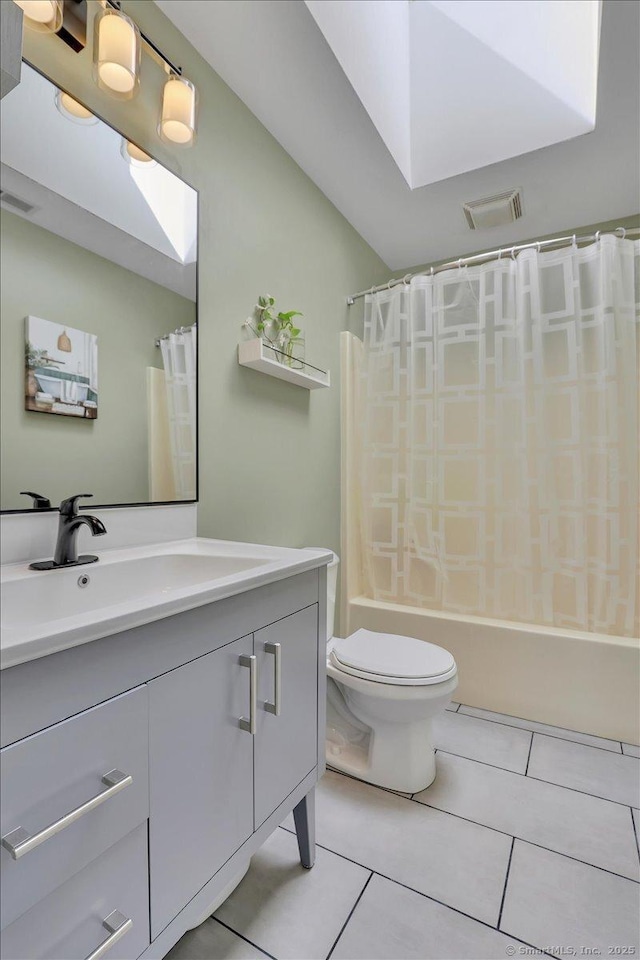 bathroom with tile patterned flooring, vanity, visible vents, and toilet