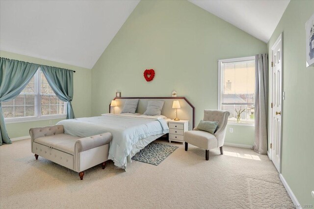 bedroom featuring high vaulted ceiling, carpet flooring, and baseboards