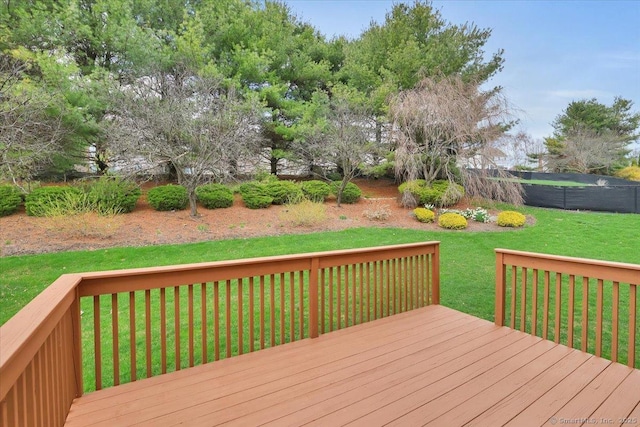 wooden deck featuring a yard