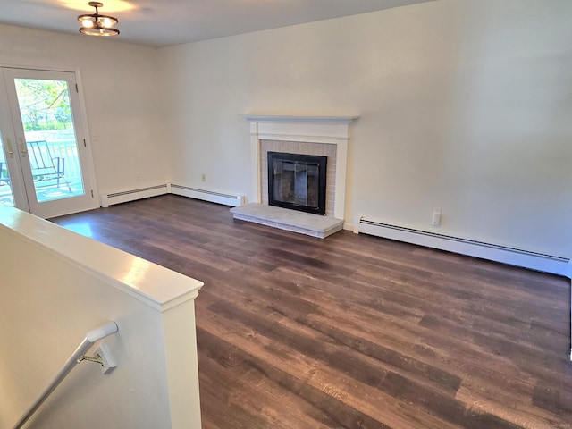 unfurnished living room with baseboard heating, a baseboard heating unit, dark wood-style floors, and a brick fireplace