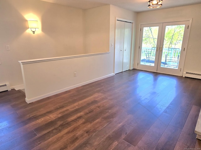 unfurnished room with baseboards, a baseboard radiator, french doors, and dark wood-style floors