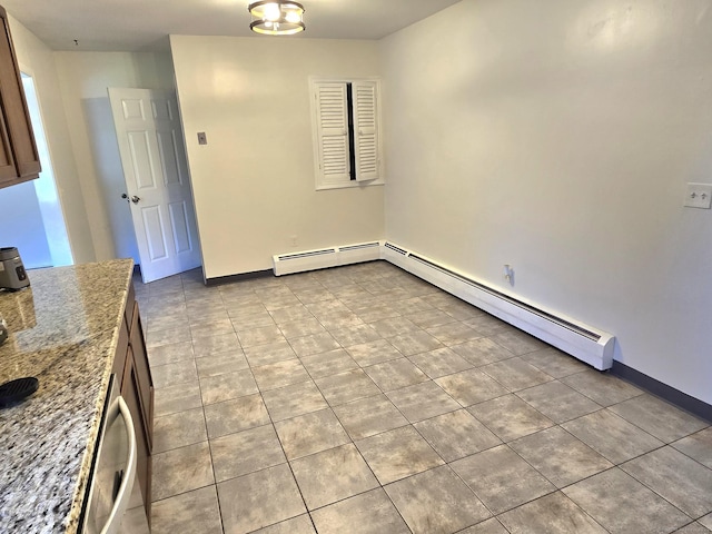 unfurnished dining area featuring baseboards, light tile patterned floors, and baseboard heating