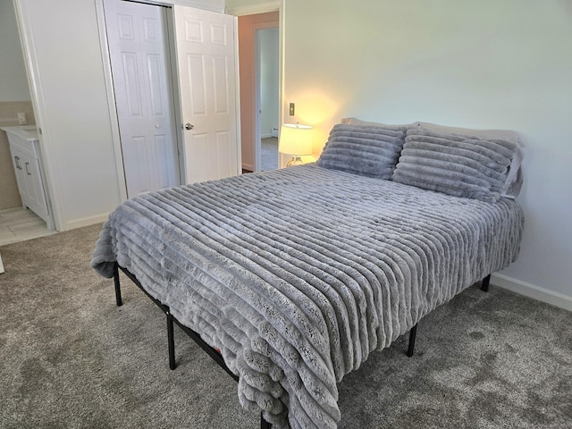 carpeted bedroom with baseboards, baseboard heating, and a closet