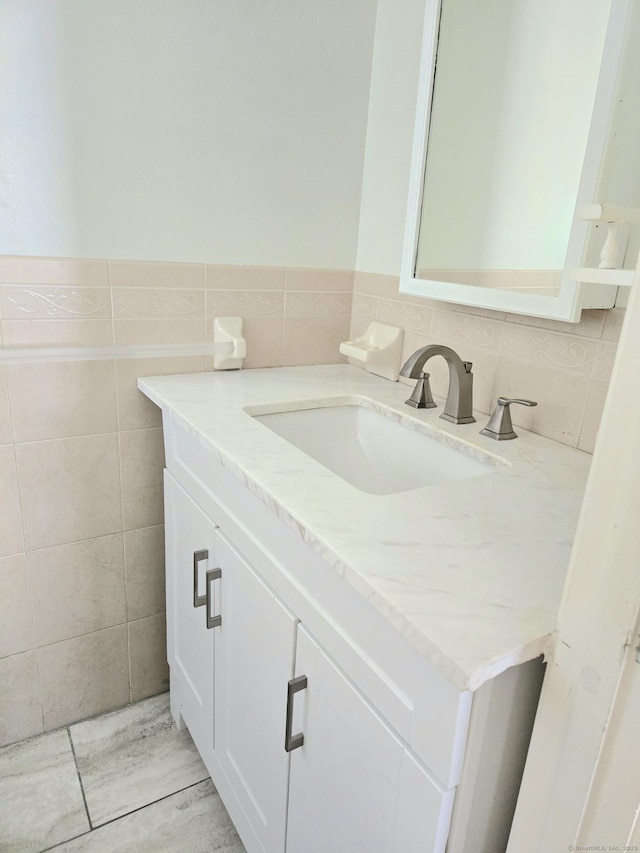 bathroom featuring tile walls and vanity