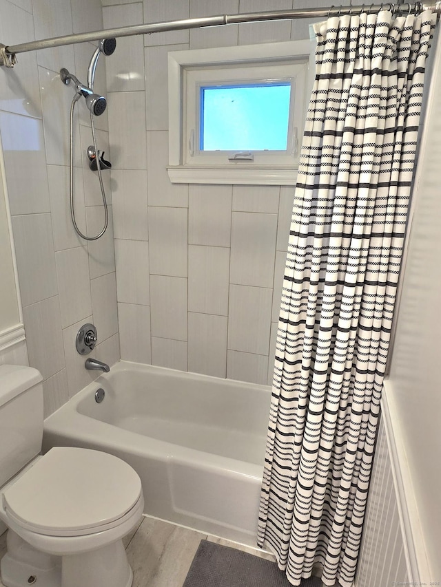 bathroom with toilet and shower / bath combo