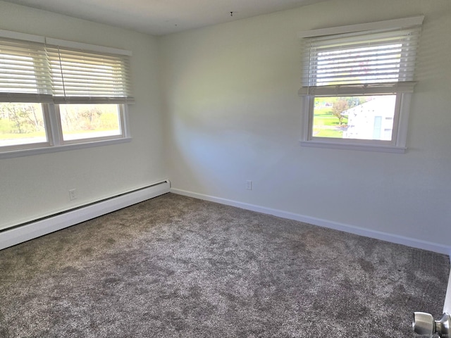 carpeted empty room featuring baseboards, plenty of natural light, and a baseboard radiator