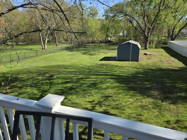 view of yard featuring fence and a storage shed