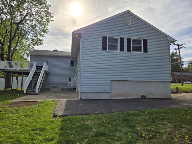 back of house with a yard, a deck, stairs, and a patio area
