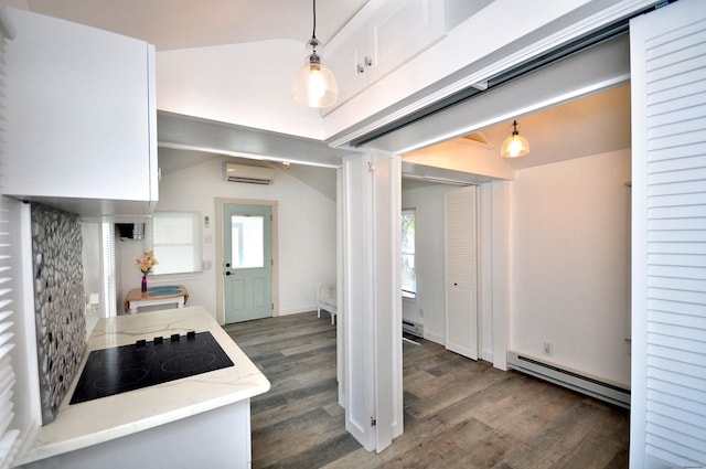 300 Mile Creek Rd, Old Lyme, CT 06371 - kitchen with baseboard heating, black electric stovetop, wood finished floors, a wall mounted air conditioner, and healthy amount of natural light
