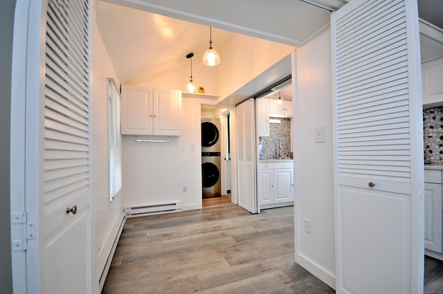 300 Mile Creek Rd, Old Lyme, CT 06371 - laundry room featuring stacked washing machine and dryer, baseboard heating, and light wood-style flooring