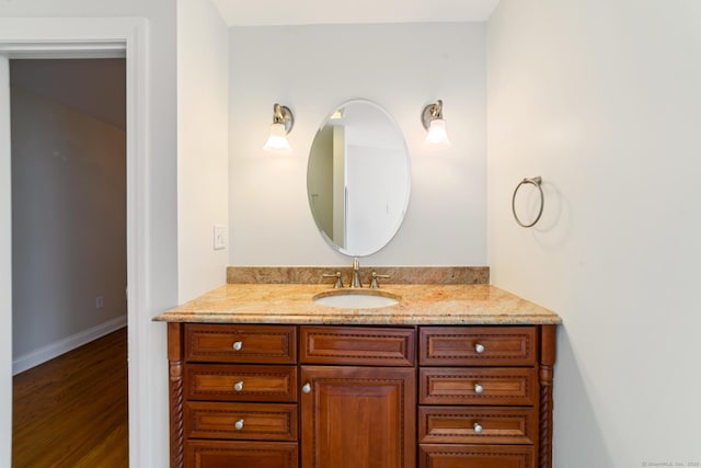 569 Lake Winnemaug Rd, Watertown, CT 06795 - bathroom with baseboards, vanity, and wood finished floors