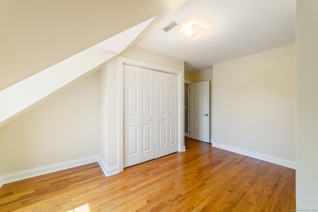 569 Lake Winnemaug Rd, Watertown, CT 06795 - additional living space with baseboards, visible vents, and light wood-style flooring