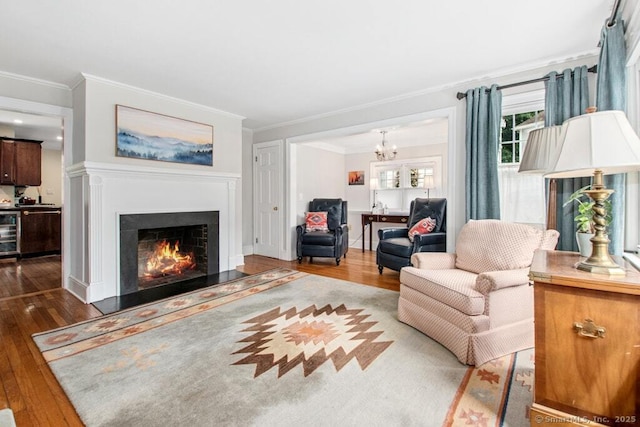 15 Devonshire Dr, Darien, CT 06820 - living room with dark wood-type flooring, crown molding, a chandelier, a lit fireplace, and beverage cooler