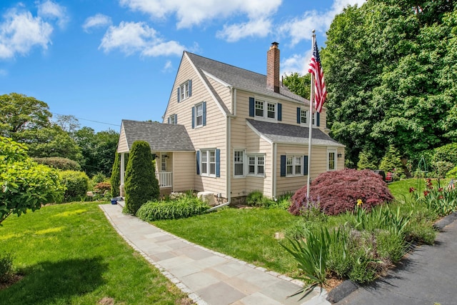 15 Devonshire Dr, Darien, CT 06820 - view of property exterior with a chimney, a shingled roof, and a yard